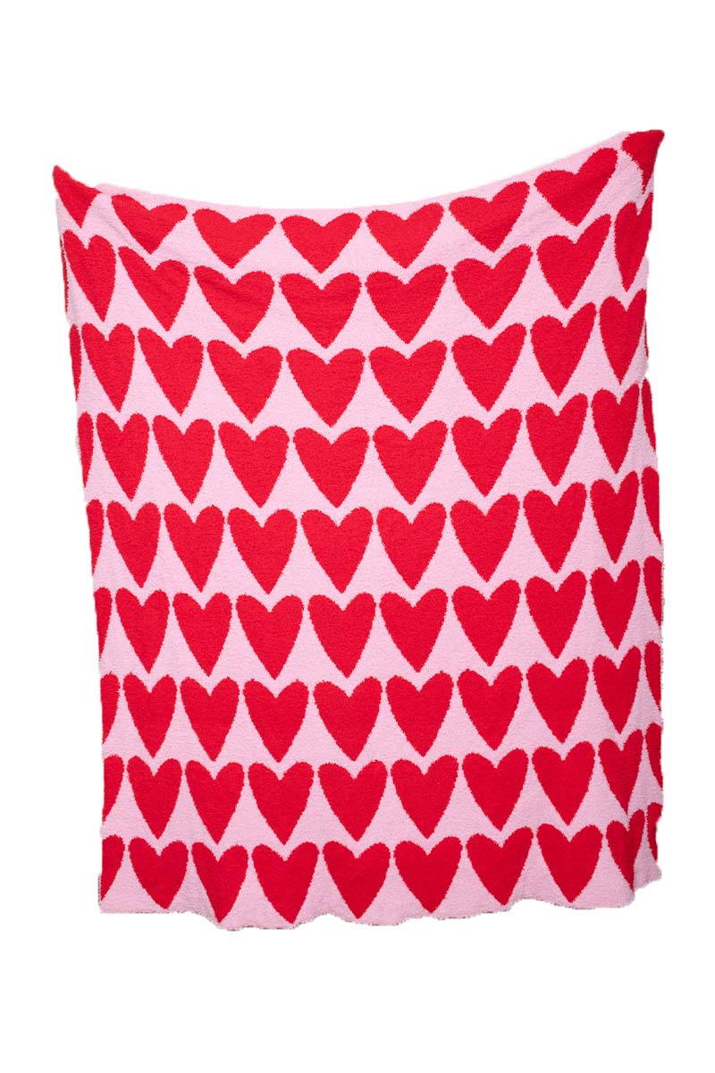 The Katydid Girly Red Hearts Comfy Oversized Throw Blanket features large red hearts on a pink background and is shown flat against a white backdrop.