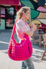 A hot pink quilted puffer tote bag