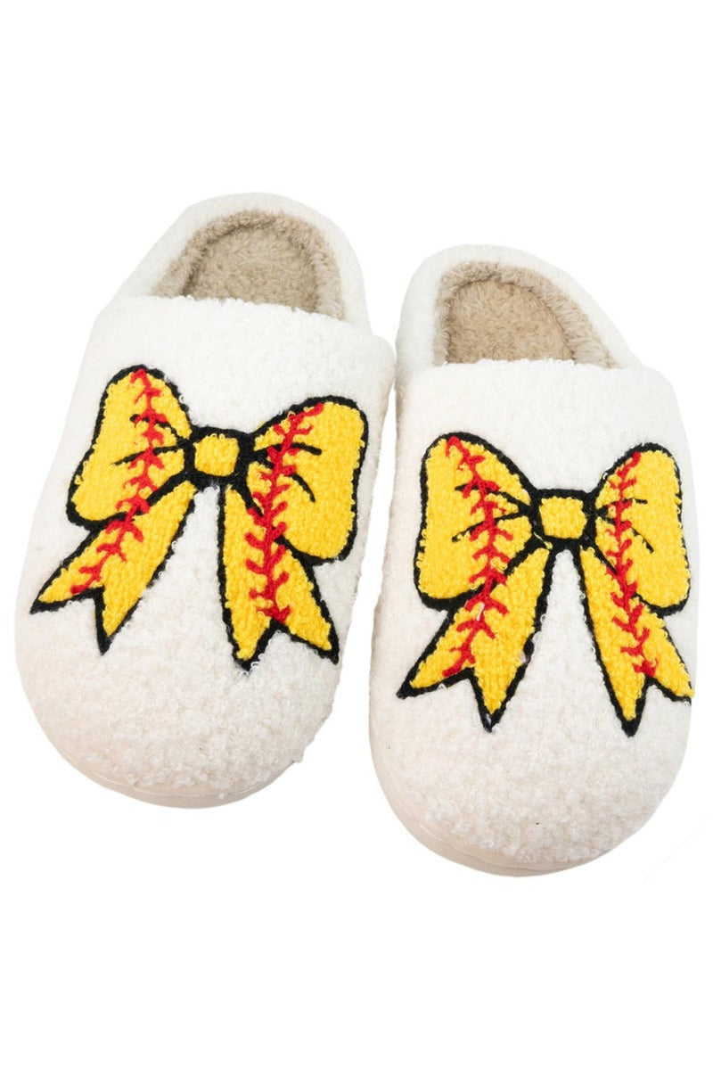 The Katydid Softball Bow Slippers are cozy and feature large yellow bows with red stitching on top, inspired by classic softball designs.