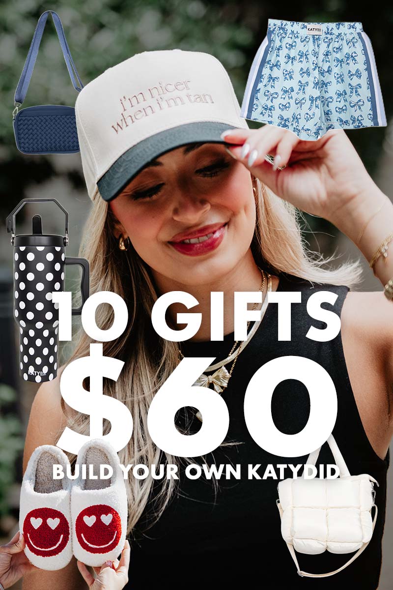 A smiling woman in a hat is surrounded by adorable accessories—a blue bag, blue shorts, a polka dot tumbler, heart slippers, and a white purse—alongside the text: 10 GIFTS FOR 60 | BUILD YOUR OWN KATYDID SET a 350 value at Katydid.com. Perfect for mixing and matching your own unique Katydid bundle.