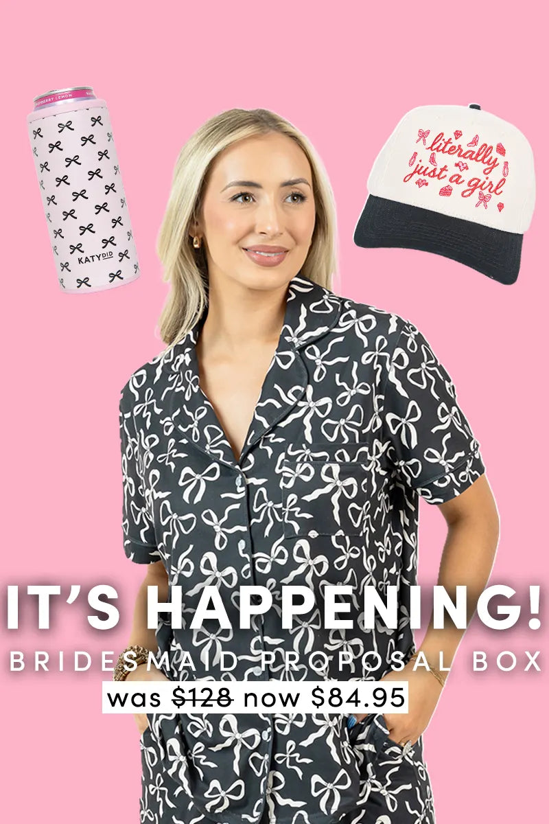 A woman in bow-print pajamas smiles before a pink backdrop with a white can cooler and “literally just a girl” hat. IT’S HAPPENING | Bridesmaid Proposal Box by Katydid.com—now 84.95, was 128. Perfect bridesmaid gift set.