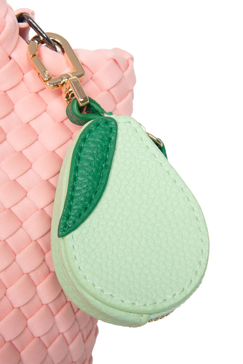 A small, light green pear-shaped keychain pouch with a green leaf is attached to a pink woven bag using a gold clasp—one of the adorable accessories you can mix and match with your Build Your Own Katydid Set 10 items for 60, a 350 value from Katydid.com.