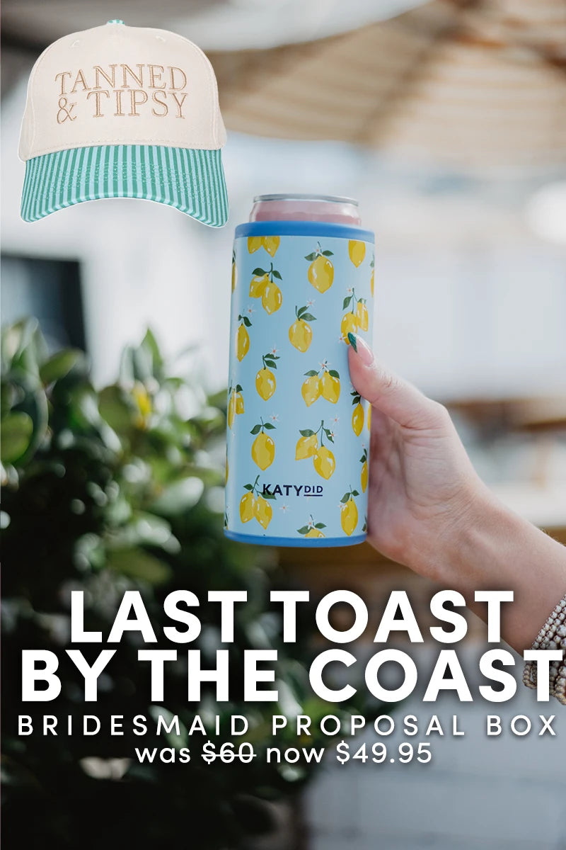 A hand holds a blue lemon-patterned can cooler. Above is a cream and teal “TANNED  TIPSY” hat. Below: Katydid.com’s Last Toast by the Coast | Bridesmaid Proposal Box—ideal for coastal bachelorettes—was 60, now 49.95.