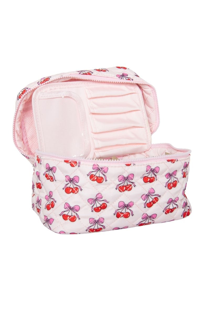 The Katydid Cherry Bows Cosmetic Bag for Makeup features a quilted design with pink cherry and bow patterns, multiple internal compartments, elastic bands for organizing, and a light pink elegant interior.