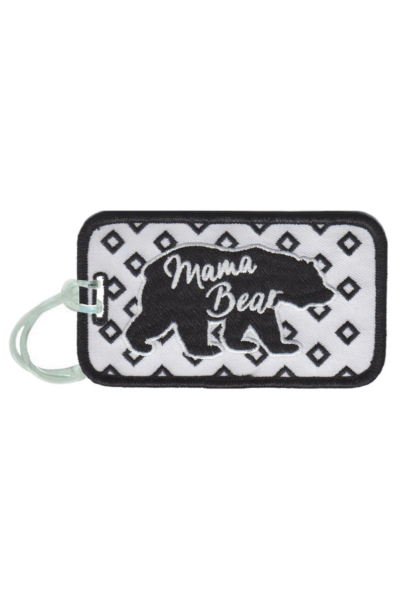 The Katydid Mama Bear Luggage Tag features a black bear silhouette and Mama Bear in white on a patterned background, plus an embroidered design and light green silicone strap for stylish detail.