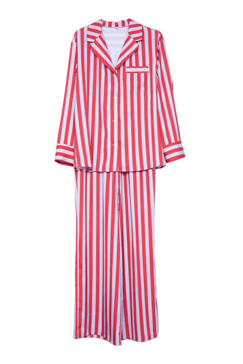 The Katydid Lilac Striped Satin PJ Set for women features a long-sleeve button-up shirt and matching long pants. Displayed against a white background, this cute set boasts stylish lilac stripes for a chic bedtime look.