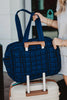 A navy duffel weekender bag