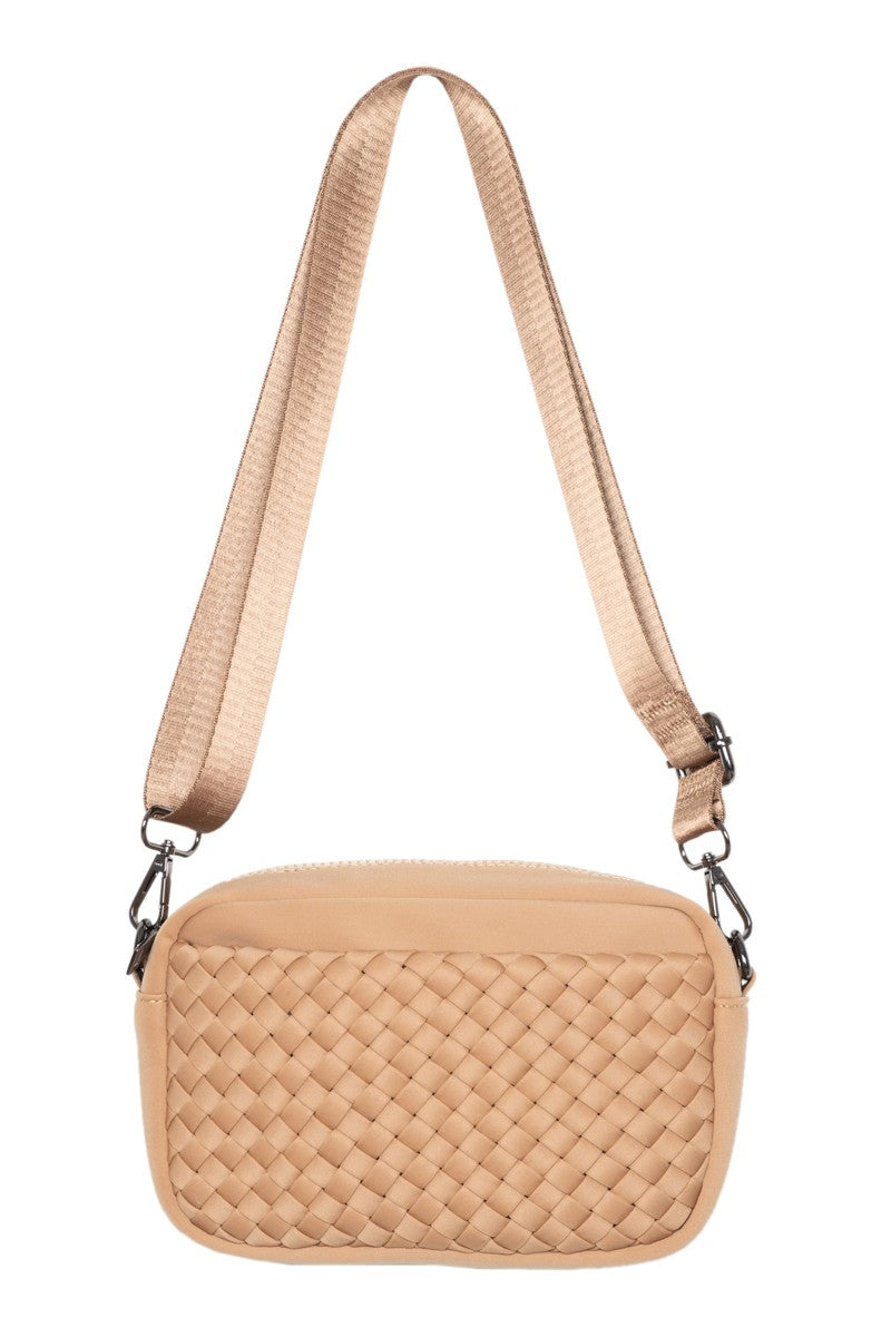 The Katydid Camel Woven Crossbody Bags Women features a wide, adjustable strap and a textured front pocket, shown against a white background.