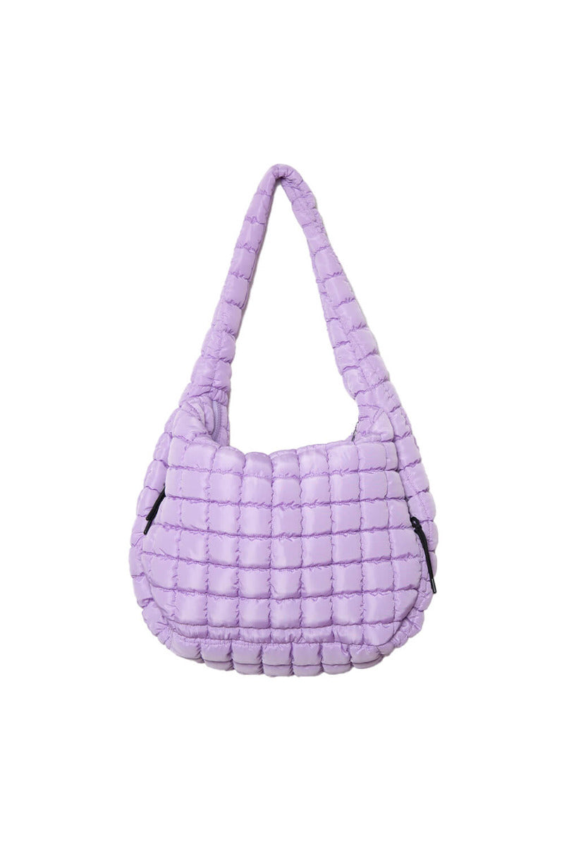 The Katydid Light Purple Oversized Carryall Tote features a quilted design, single strap, soft puffy texture, and zipper closure, shown against a plain white background.