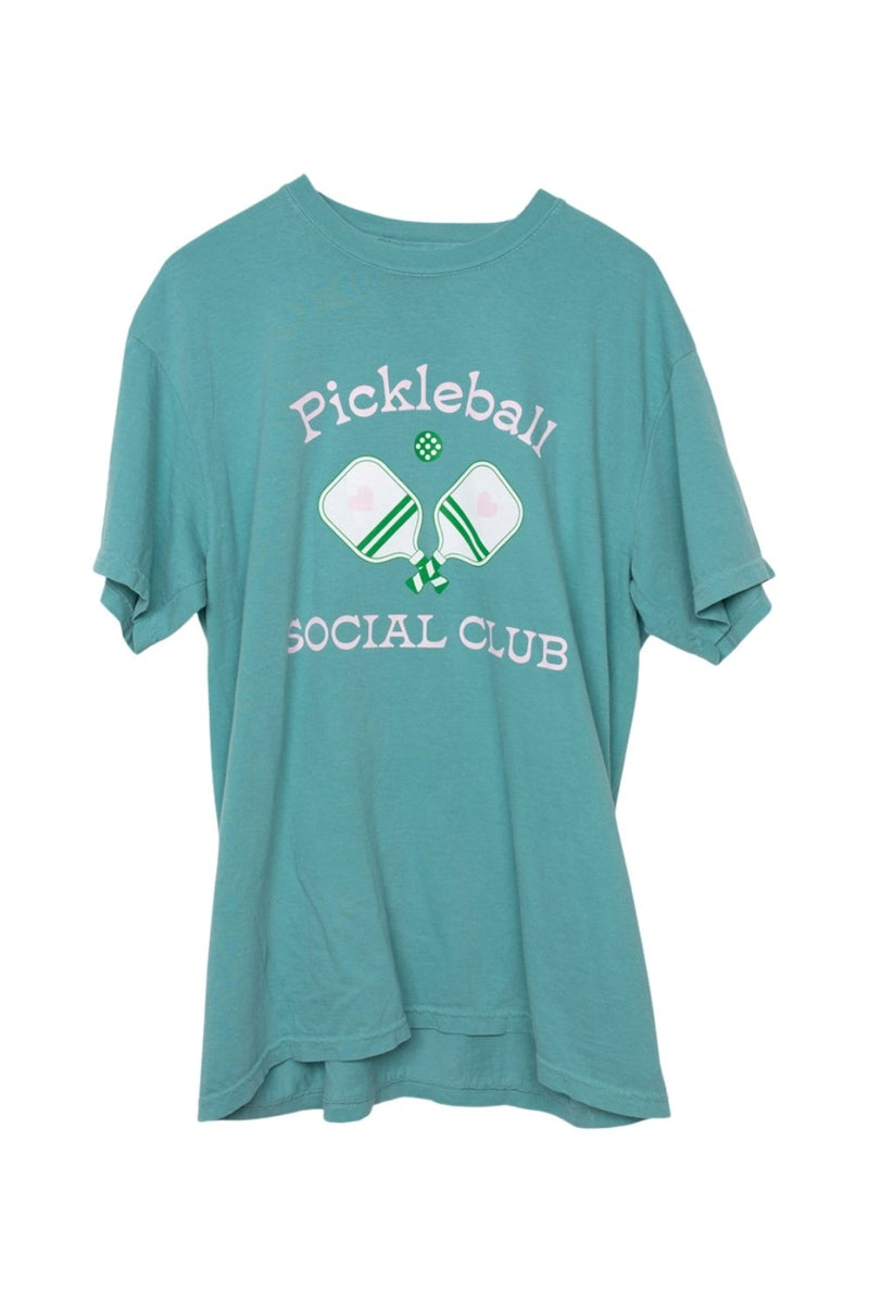 The Katydid Pickleball Social Club Womens Graphic Tee is a teal shirt with “Pickleball Social Club,” featuring two paddles, a small ball, and a green pickle.