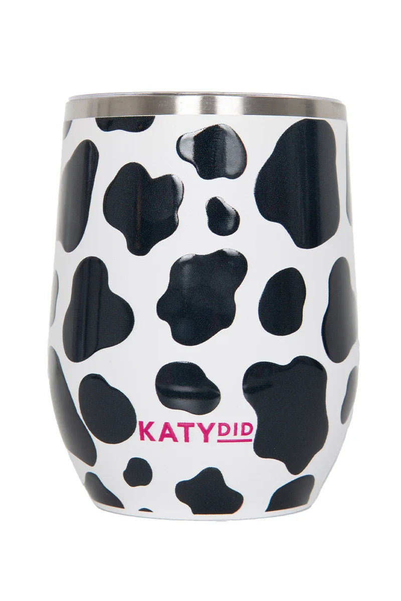 The Katydid Cow Print Wine Tumbler Cup With Lid features a chic cow print design, pink KATYDID branding near the base, and insulated stainless steel to keep drinks perfectly tempered.