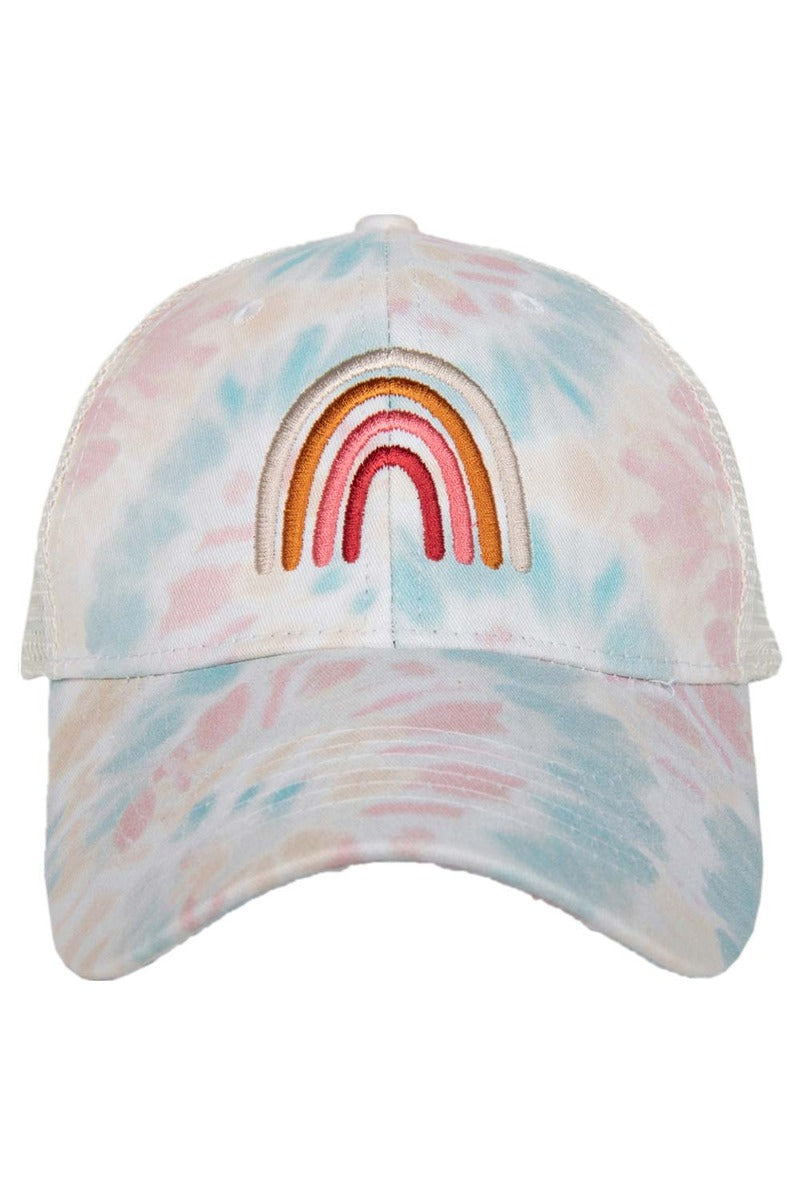 A tie dye trucker hat with a rainbow embroidered on the front