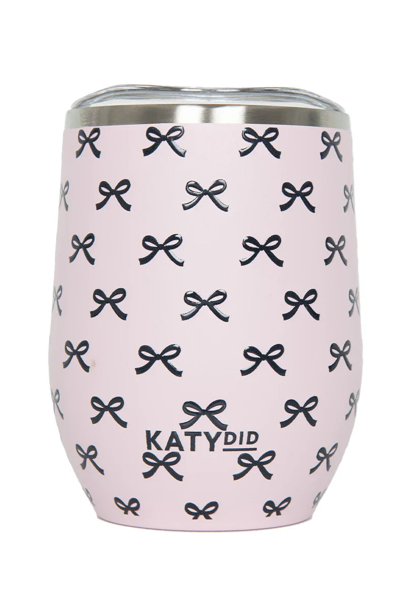 The Katydid Black  Pink Mini Bows Wine Tumbler Cup features small black bows, a stainless steel rim, and insulation to keep drinks at the perfect temperature. Brand name appears near the bottom.