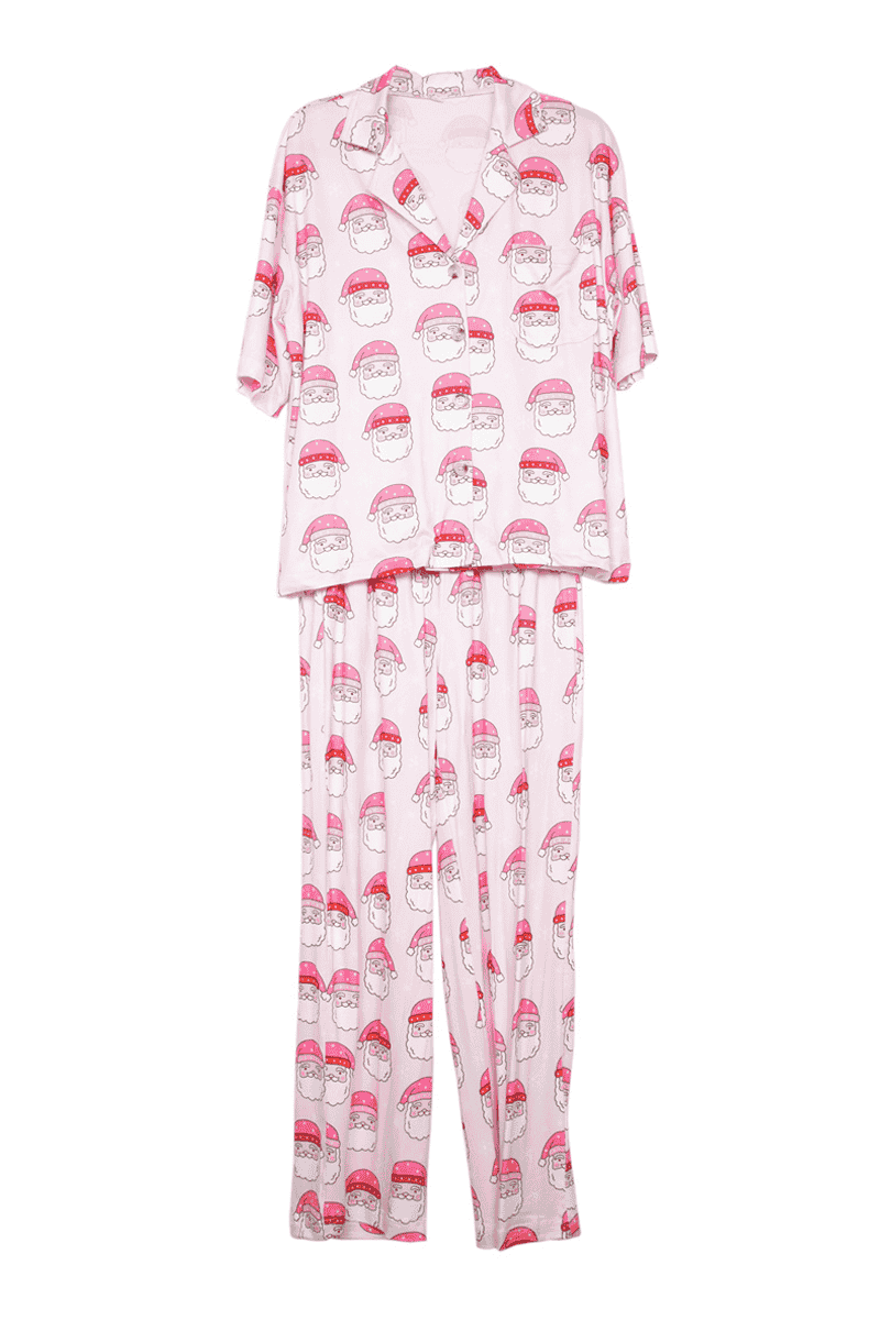The Katydid Pink Santa Face Pajama Pants Set features short sleeves, long pants, and a button-up collared top with a playful red and white Santa face pattern—perfect women’s pajamas for festive holiday comfort.