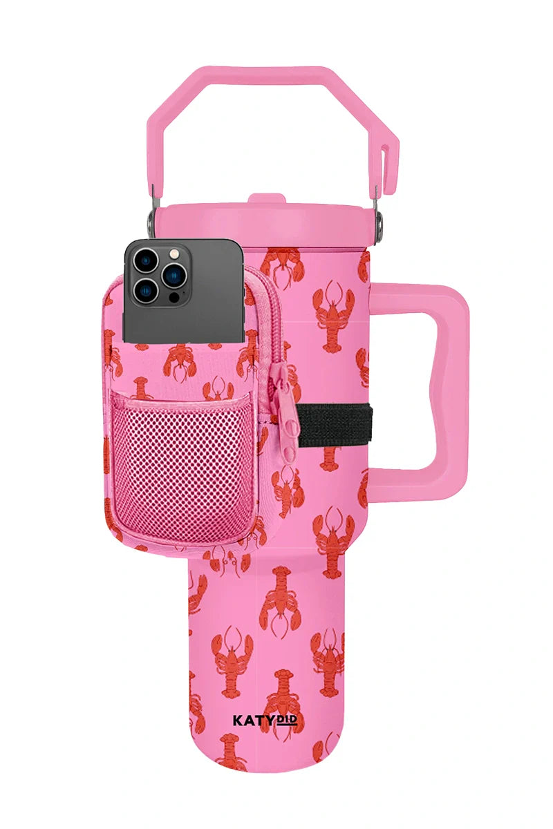 The Katydid Lobsters Bag for Tumbler is a large pink insulated cup with a handle and red lobster prints, featuring a matching pouch on the front for holding a smartphone. KATYDID appears near the base.