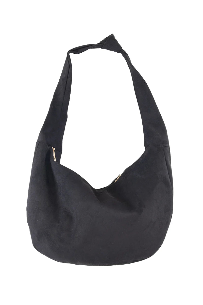The Katydid Black Spacious Suede Tote Bag features a wide strap and soft, unstructured shape, making it an ideal womens handbag for fall. Pictured against a plain white background.