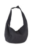 The Katydid Black Spacious Suede Tote Bag features a wide strap and soft, unstructured shape, making it an ideal womens handbag for fall. Pictured against a plain white background.