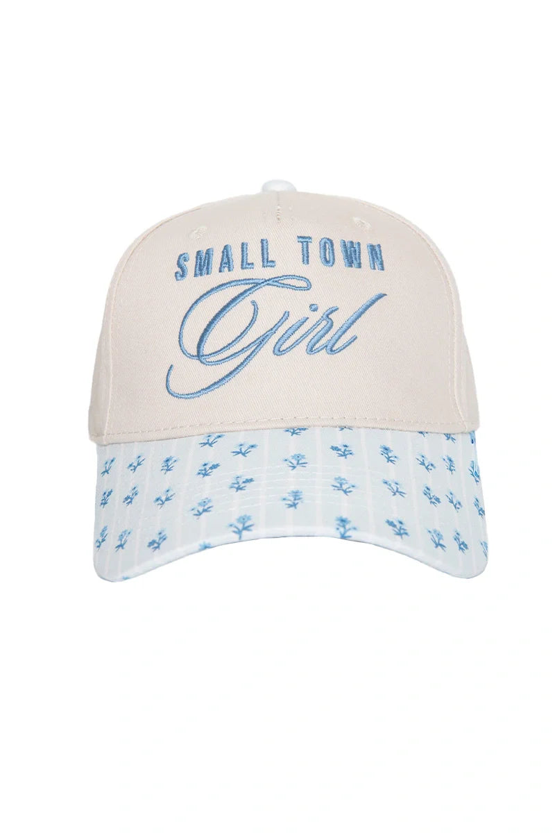 The Katydid Small Town Girl Vintage Trucker Hat for Women features a beige design with blue embroidery and a light blue, floral-patterned bill—a nostalgic, country-cute accessory for any outfit.