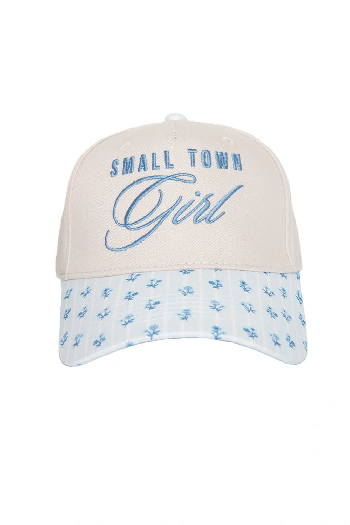 The Katydid Small Town Girl Vintage Trucker Hat for Women features a beige design with blue embroidery and a light blue, floral-patterned bill—a nostalgic, country-cute accessory for any outfit.