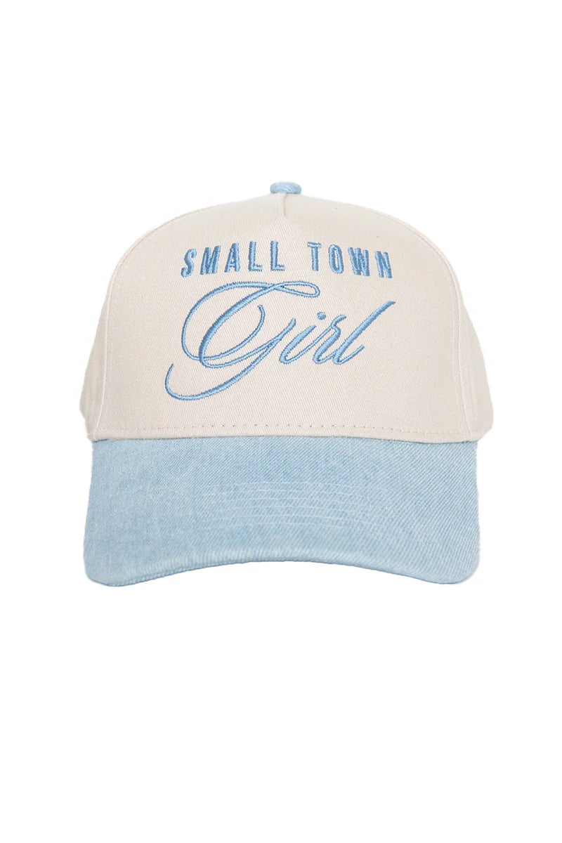 The Katydid Small Town Girl Vintage Trucker Hat for Women features a beige crown, light blue brim, and SMALL TOWN Girl embroidered in blue script—an ideal country-cute accessory.