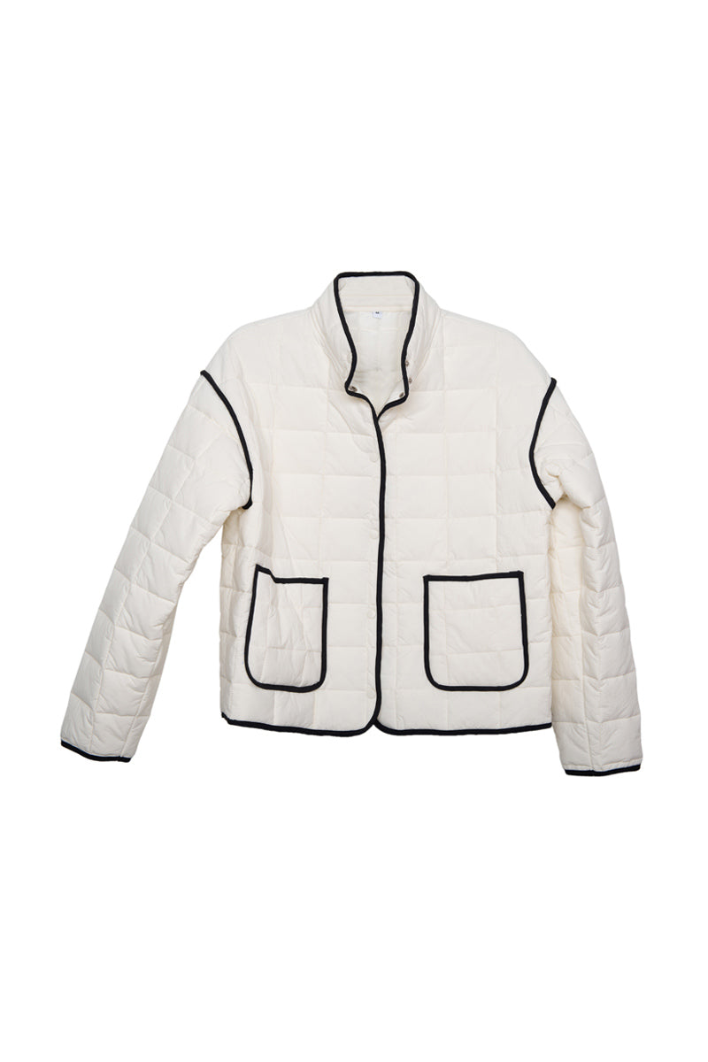 The Katydid White Quilted Trim Jacket for Women features a collarless design, black piping on the edges and pockets, plus two front pockets for style and function.