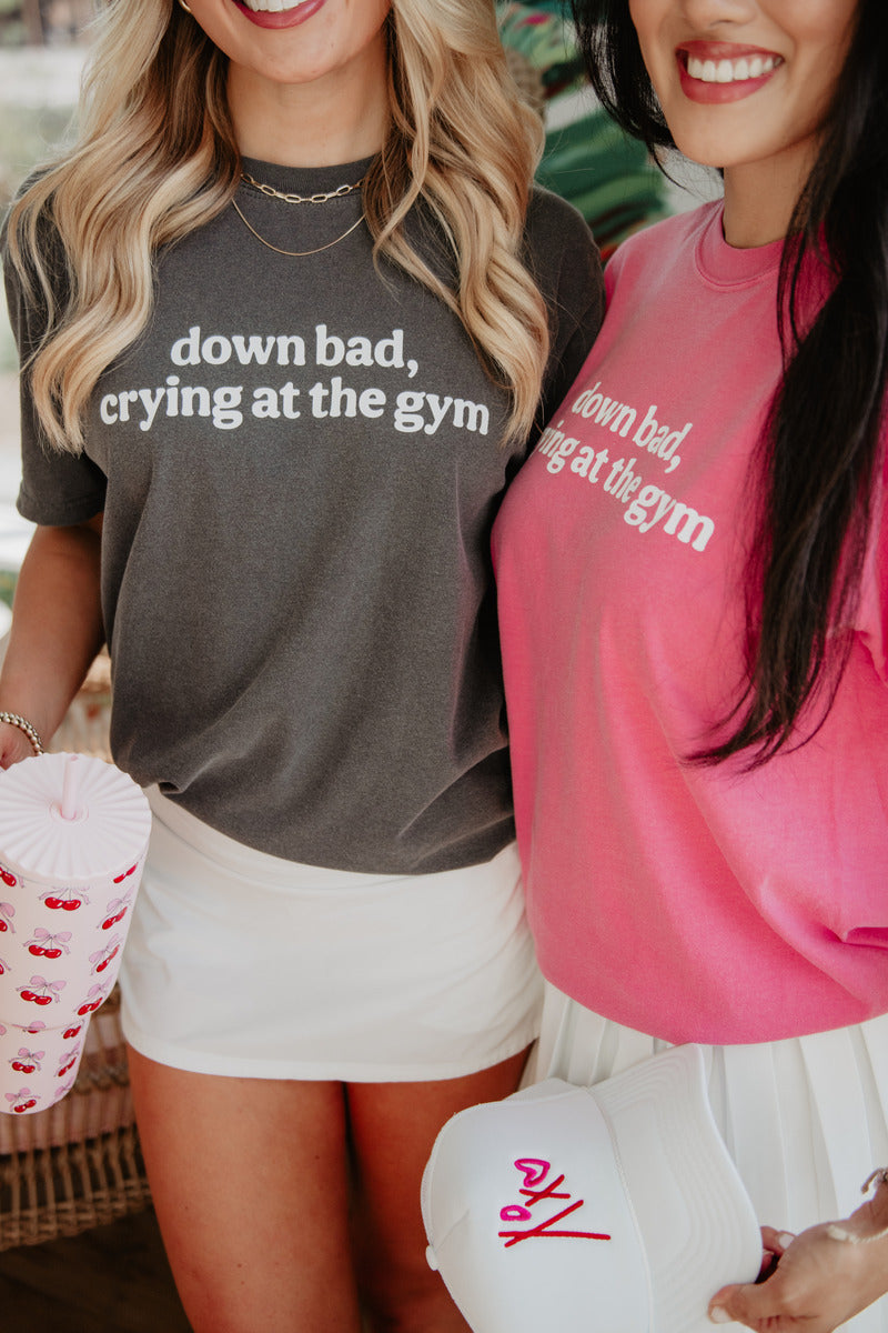 two women standing next to each other wearing matching down bad crying at the gym shirts