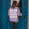 the back of a woman walking through a door wearing a purple women’s dog sweatshirt